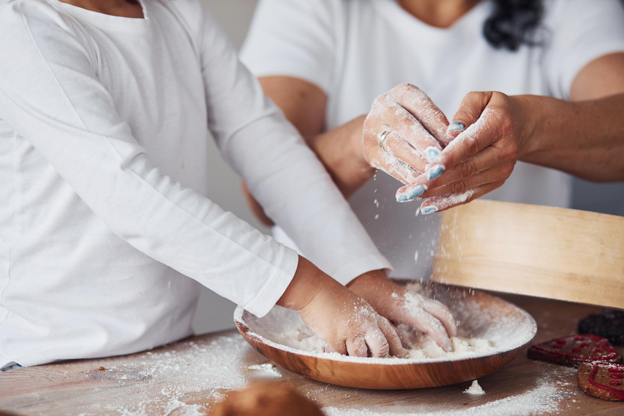 Students in a culinary masterclass preparing dough